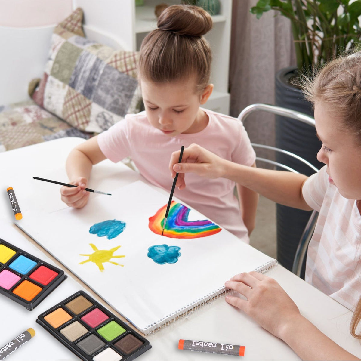 Kids painting with the watercolor cakes from the art set