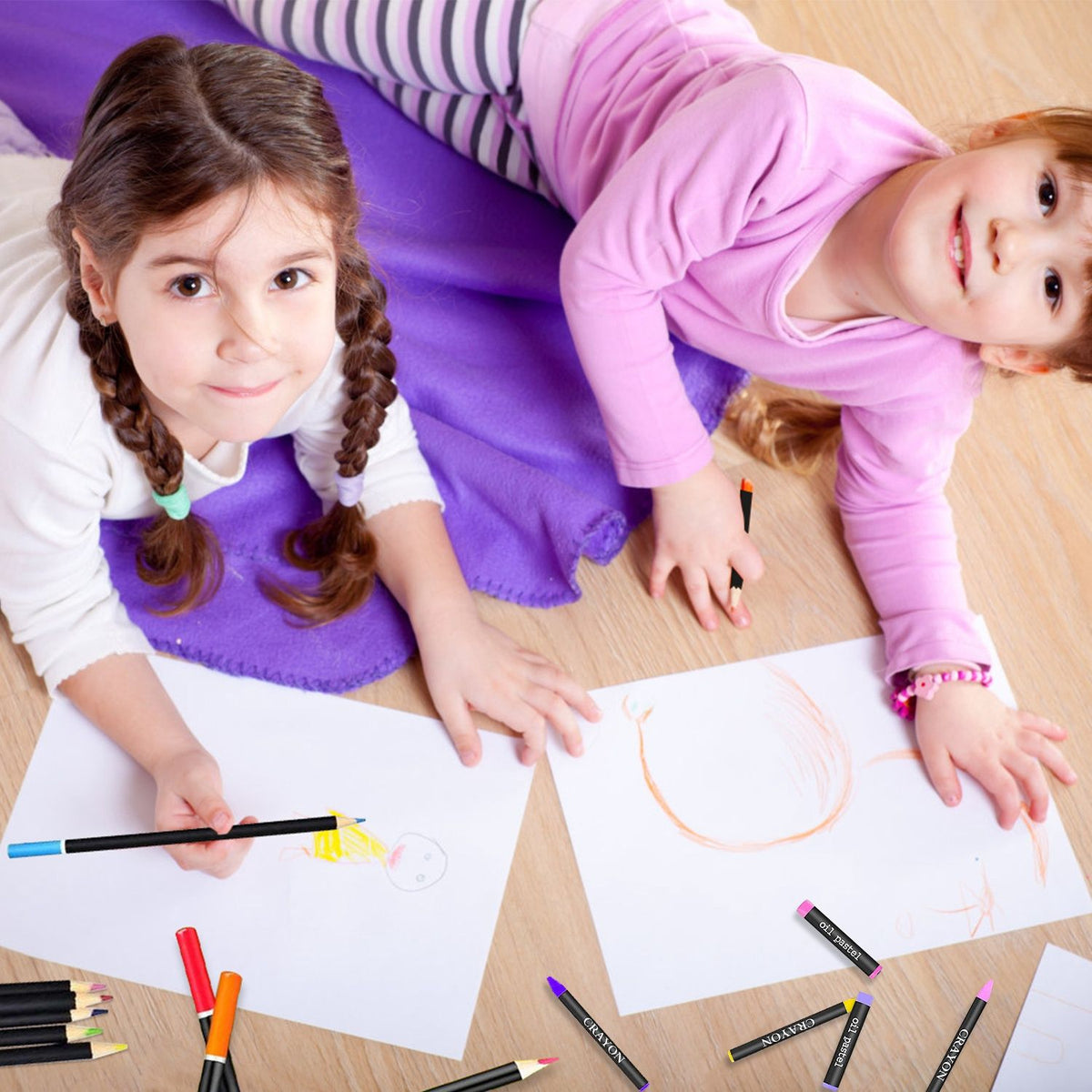Girls drawing with colored pencils from the art set